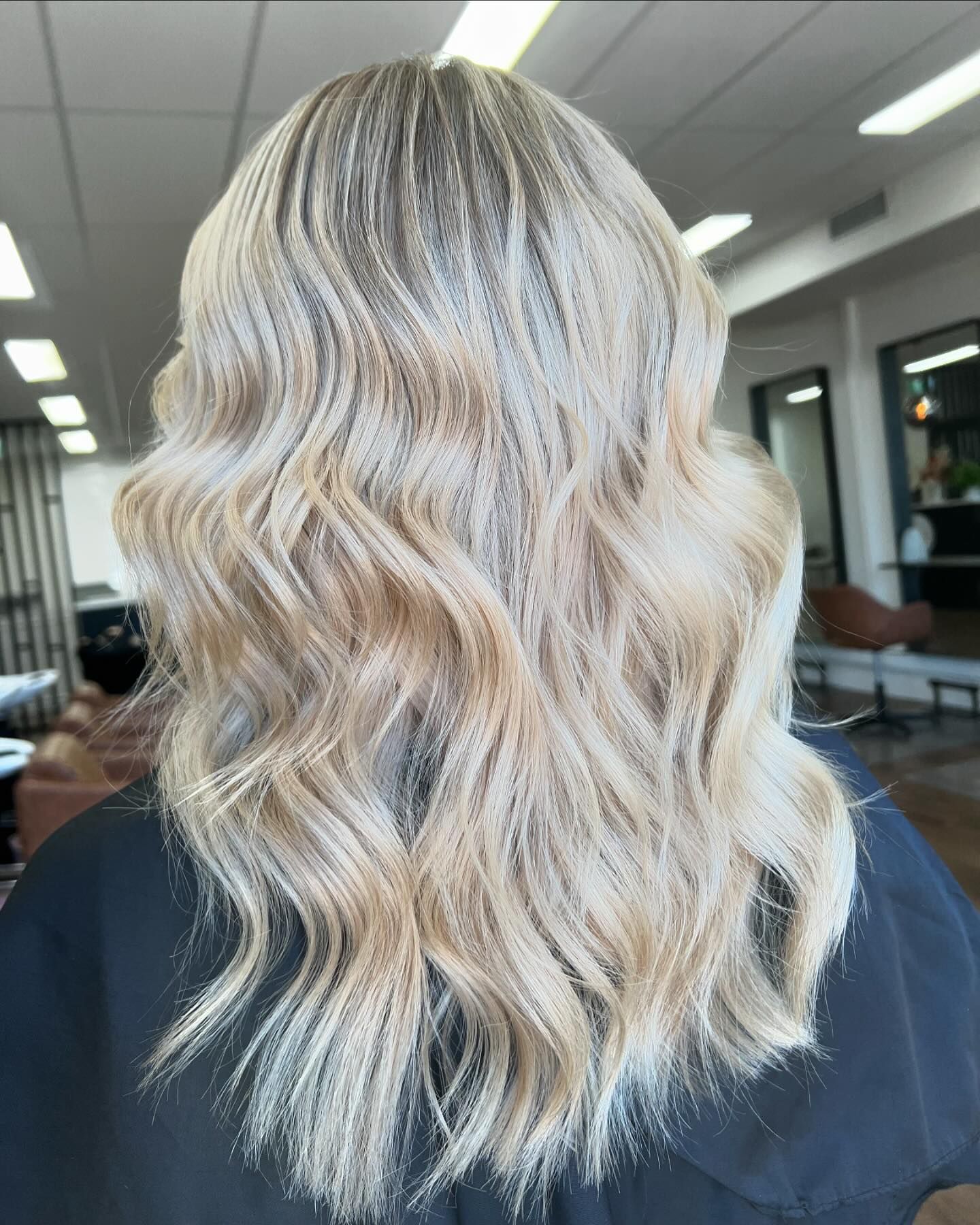 A woman with blonde hair is sitting in a chair in a salon. — Mysa on Flinders In Townsville City, QLD