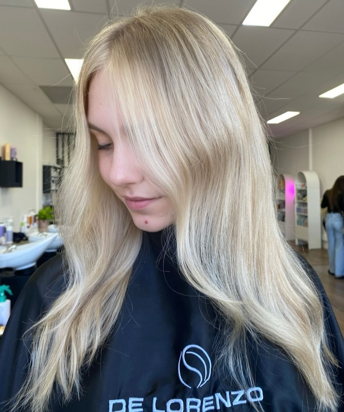 A woman with blonde hair is wearing a black cape in a salon. — Mysa on Flinders In Townsville City, QLD