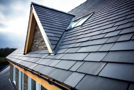 Dark gray tiled roof with a dormer and skylight.