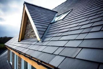 Dark gray tiled roof with a dormer and skylight.