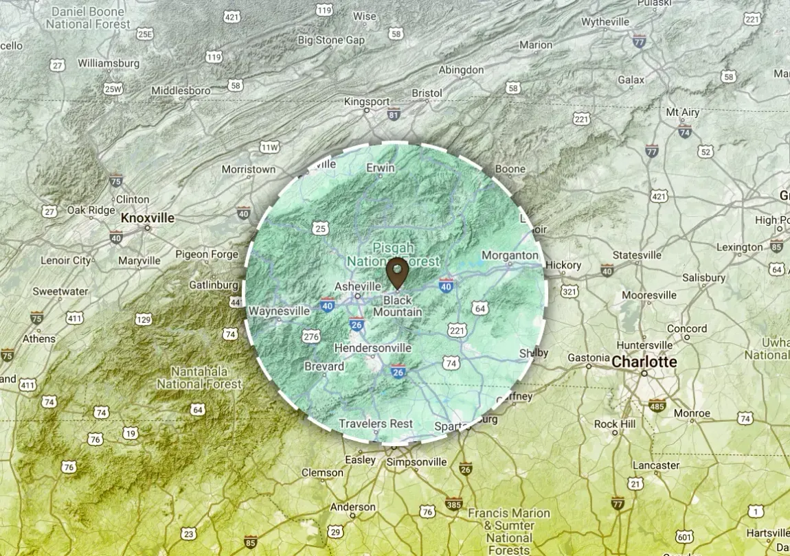 Map highlighting an area in green with a location marker at the center, surrounded by roads and towns.