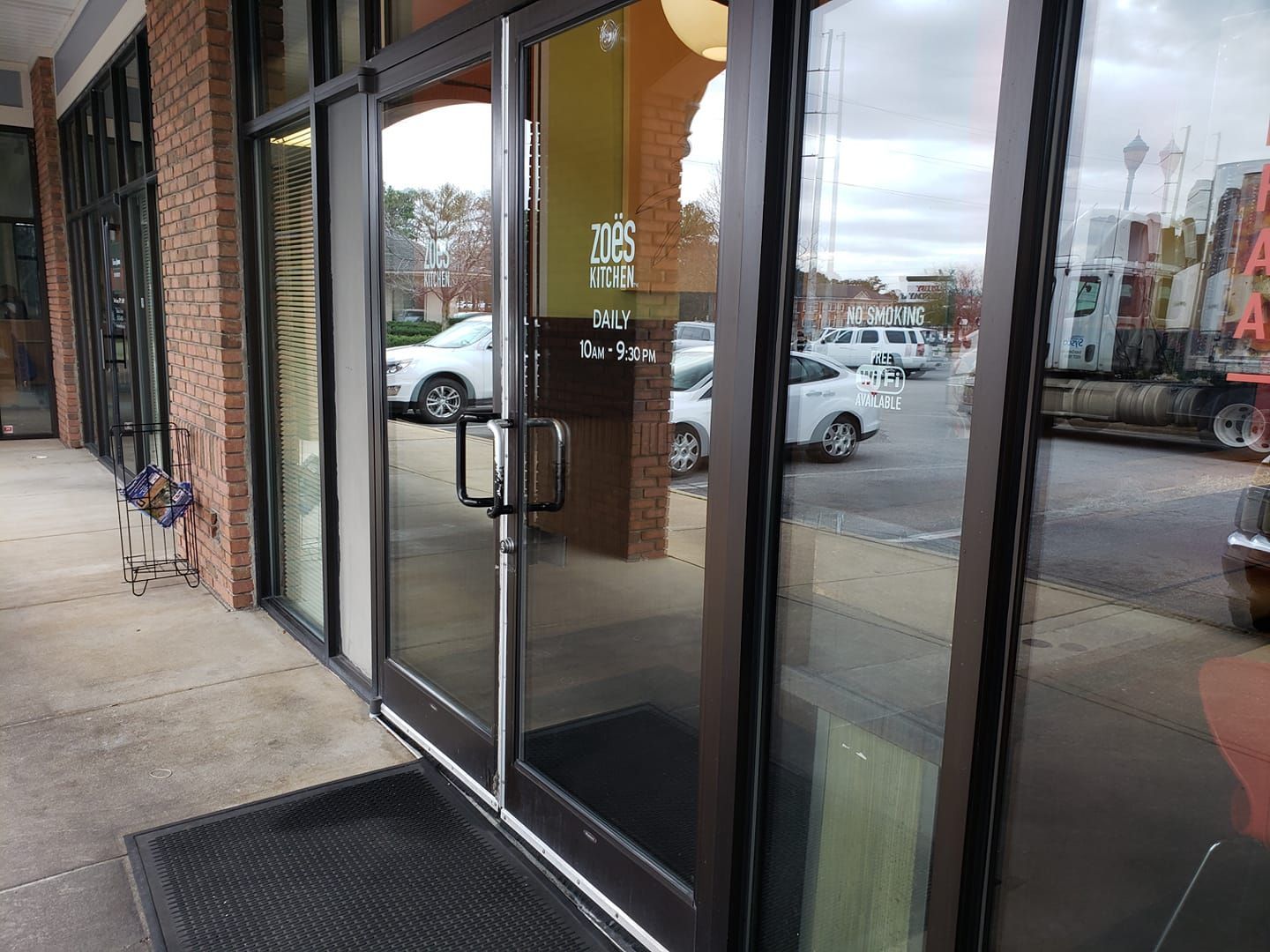 A building with a lot of windows and a truck parked in front of it.