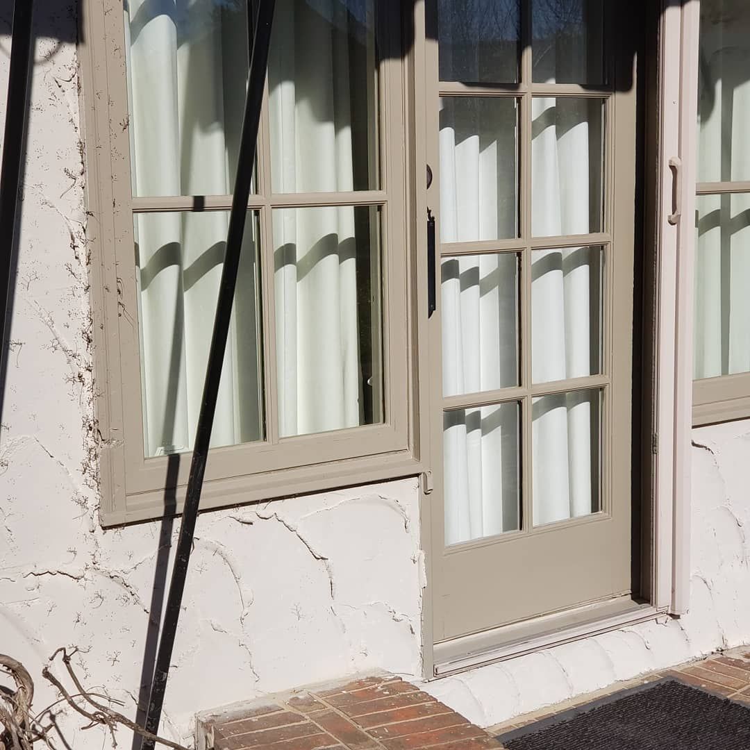 A french door with a black mat in front of it