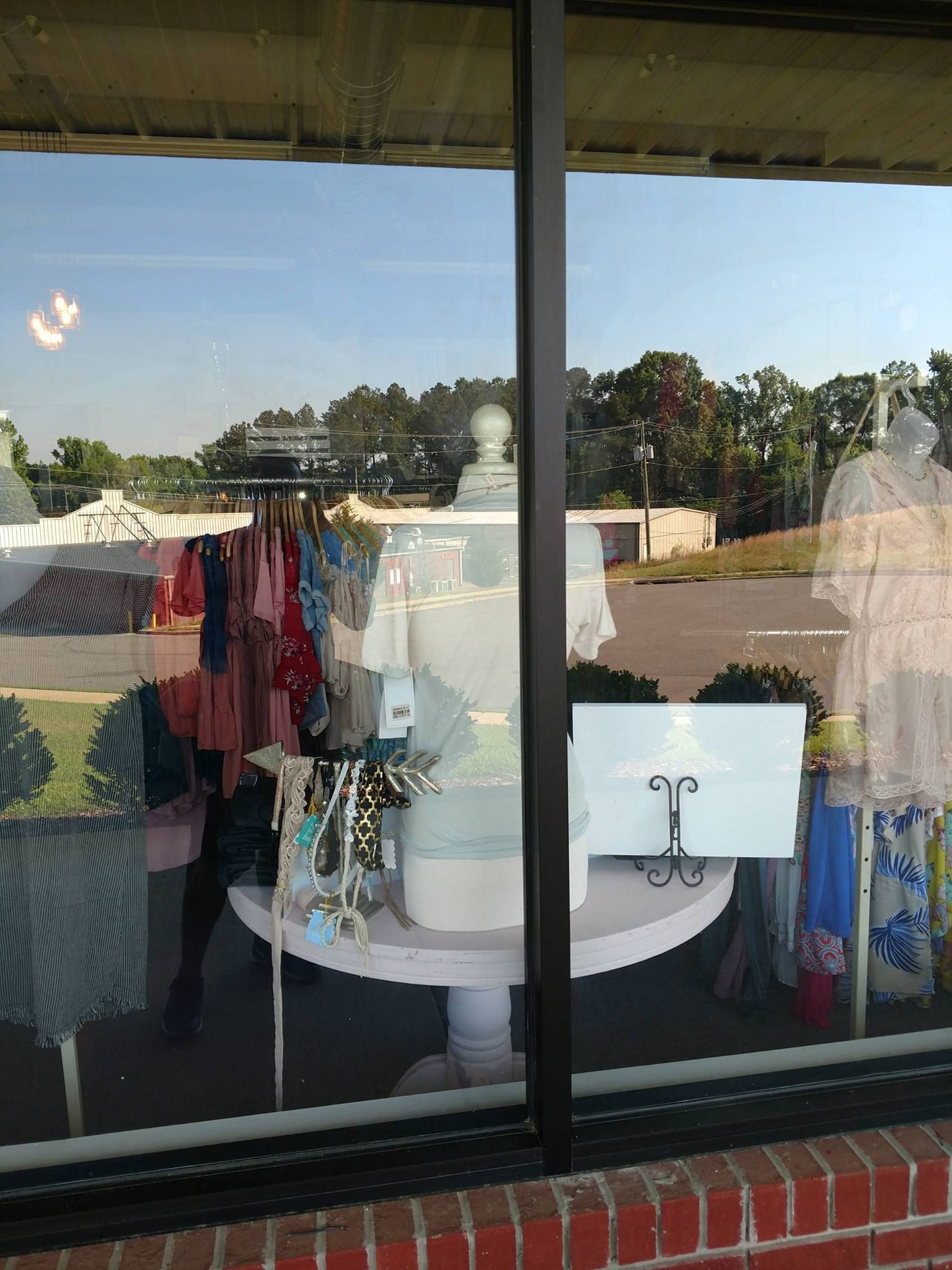 A store window with a lot of clothes on display