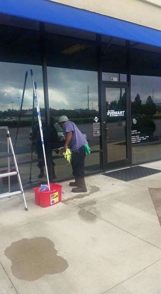 A man is cleaning the windows of a building.