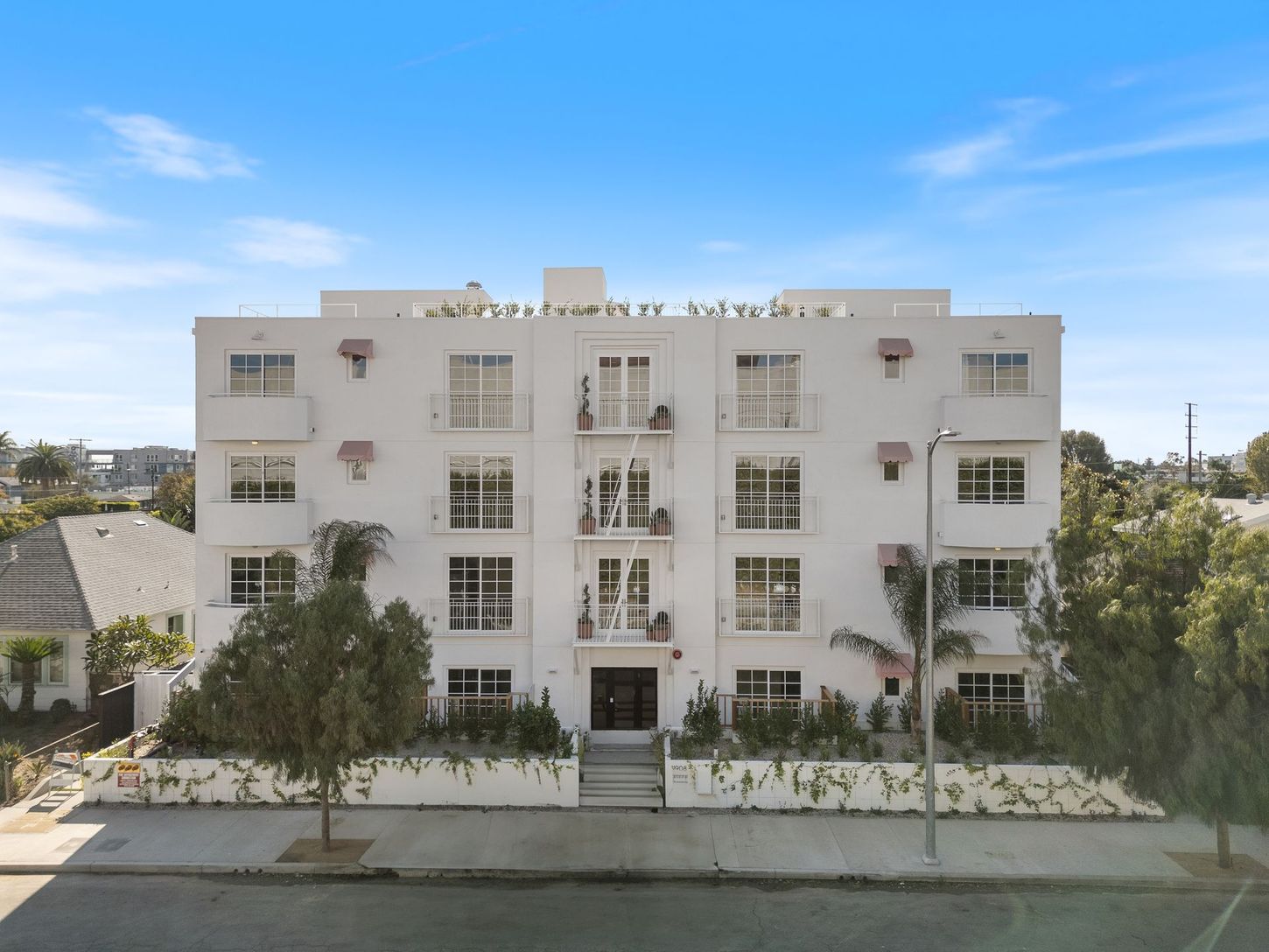 An aerial view of a large white apartment building