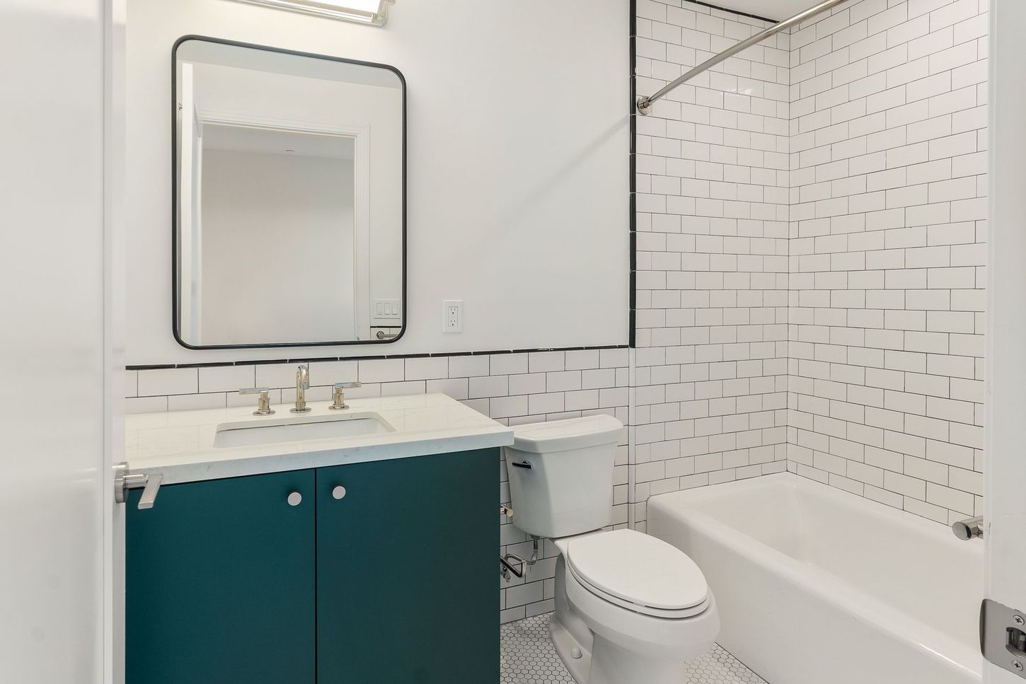 A bathroom with a toilet , sink , and bathtub.