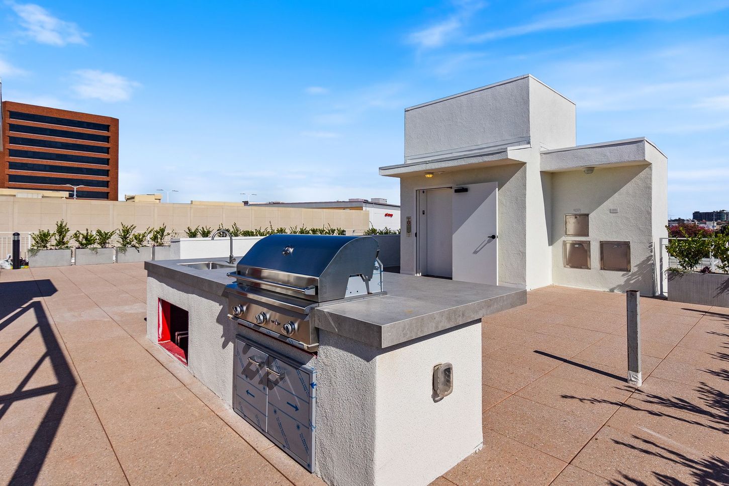 A rooftop grill with a stainless steel grill on it