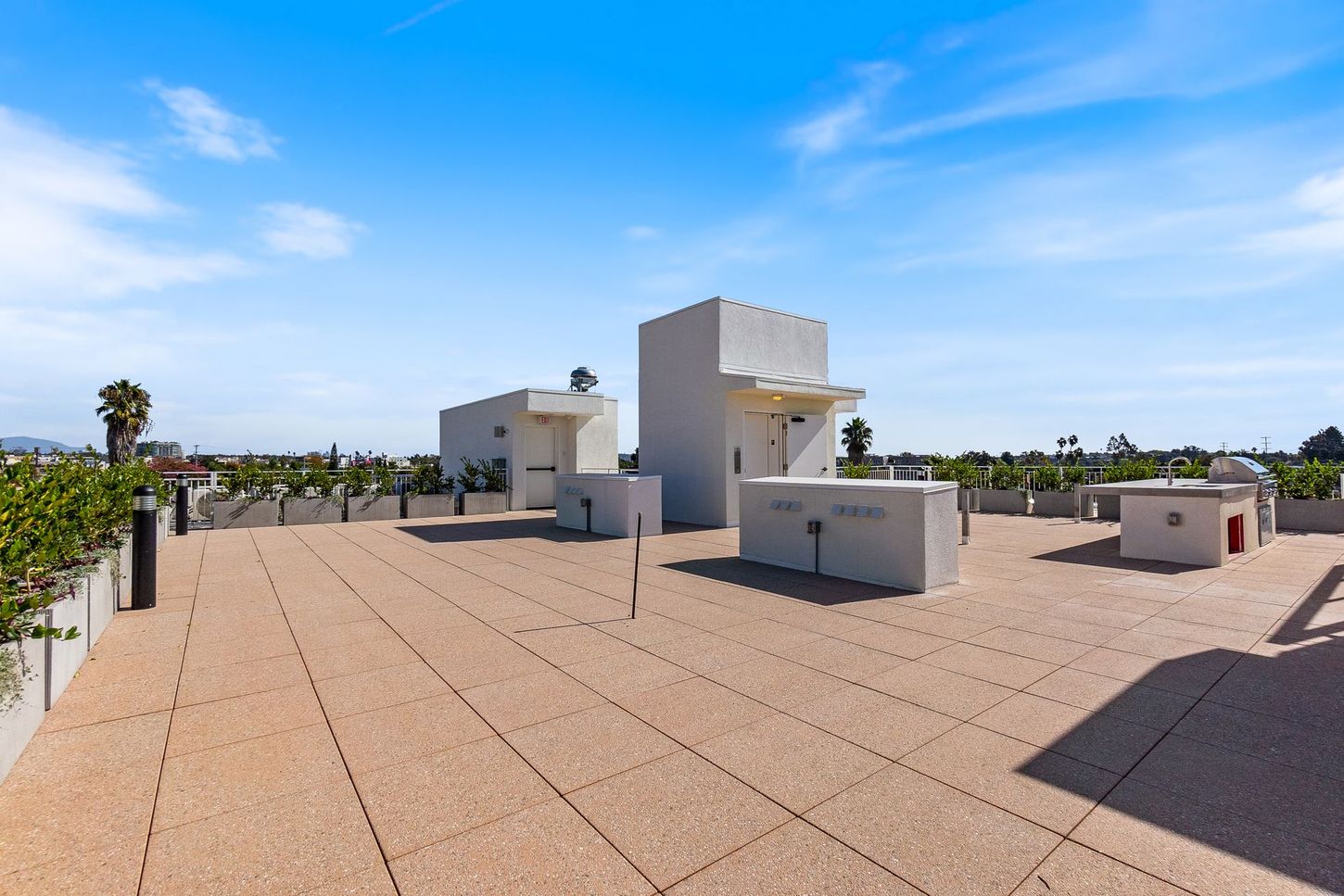 A rooftop with a few buildings on it and a blue sky