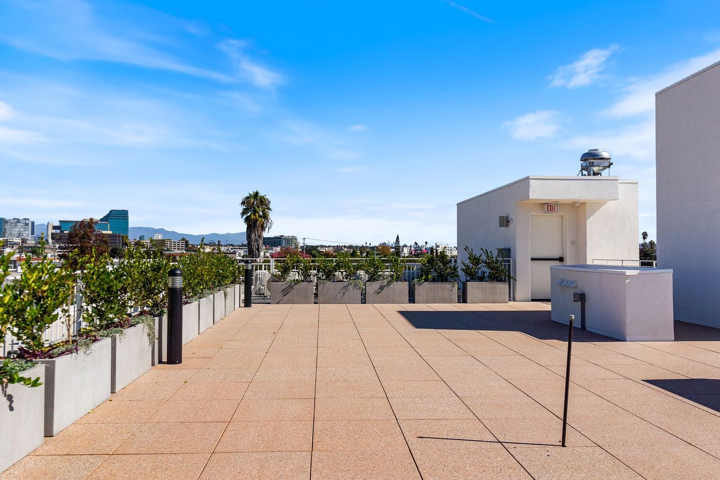 A rooftop terrace with a view of a city.