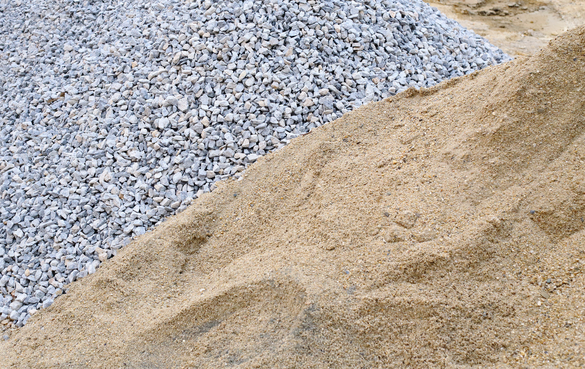 A pile of gravel and sand are stacked on top of each other.