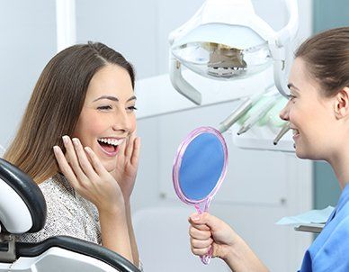 Dentist Patient Checking Whitening Results — Empire, MI — Empire Family Dental