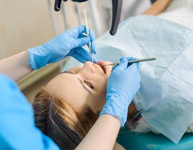 Dentist Treating Caries Using Microscope — Empire, MI — Empire Family Dental