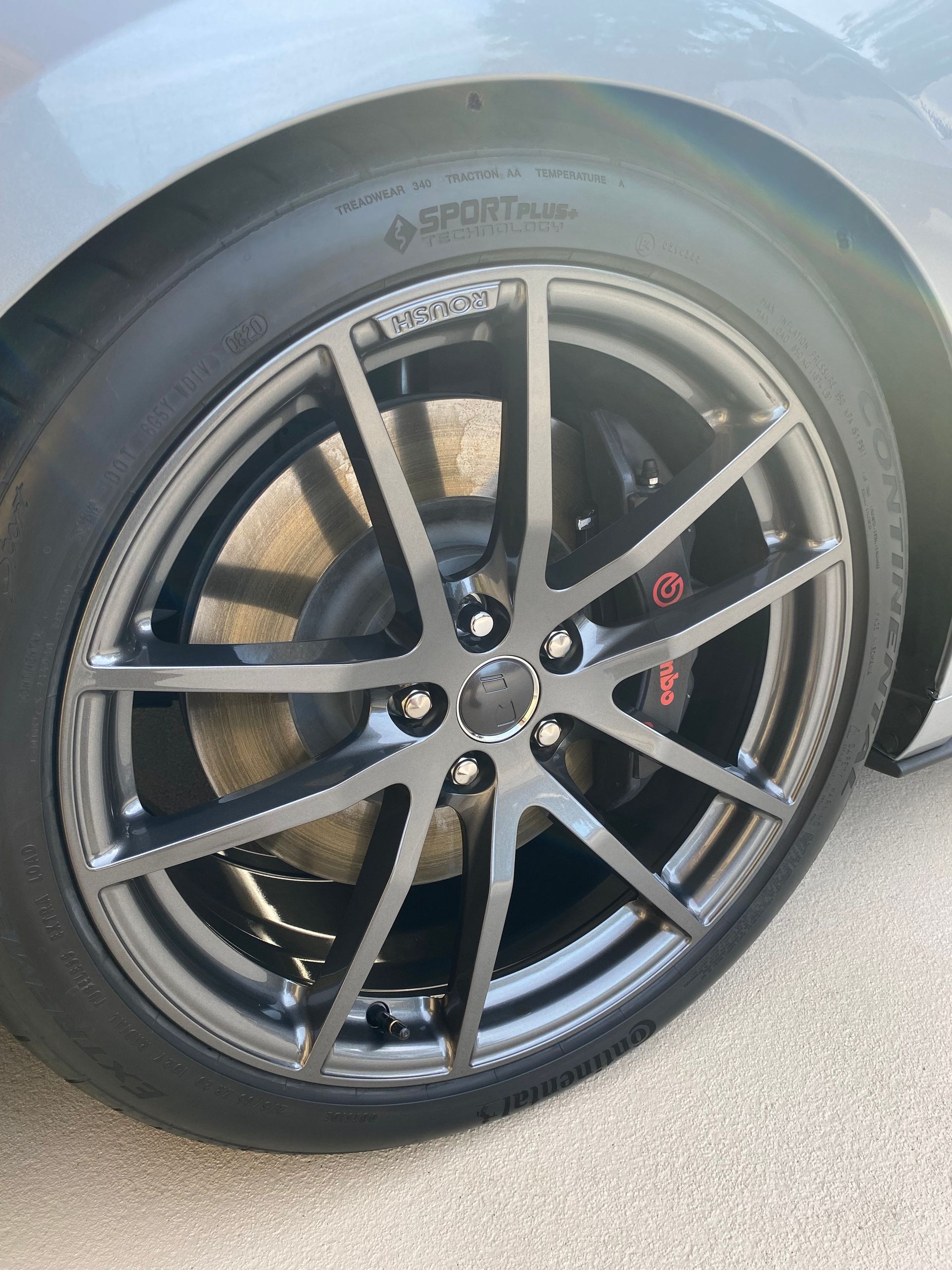 A close up of a car wheel with the word sport on it