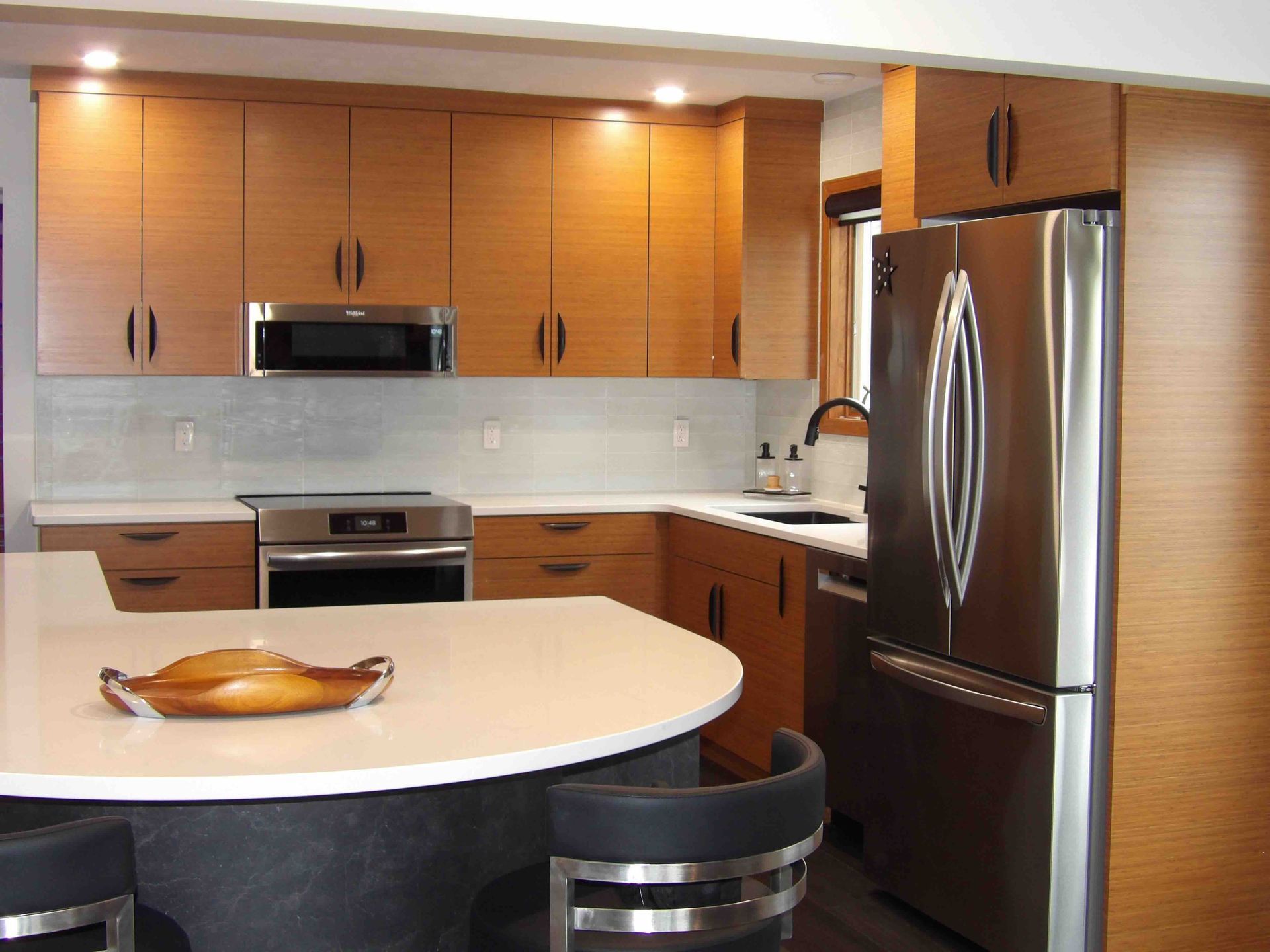 A kitchen with stainless steel appliances and wooden cabinets