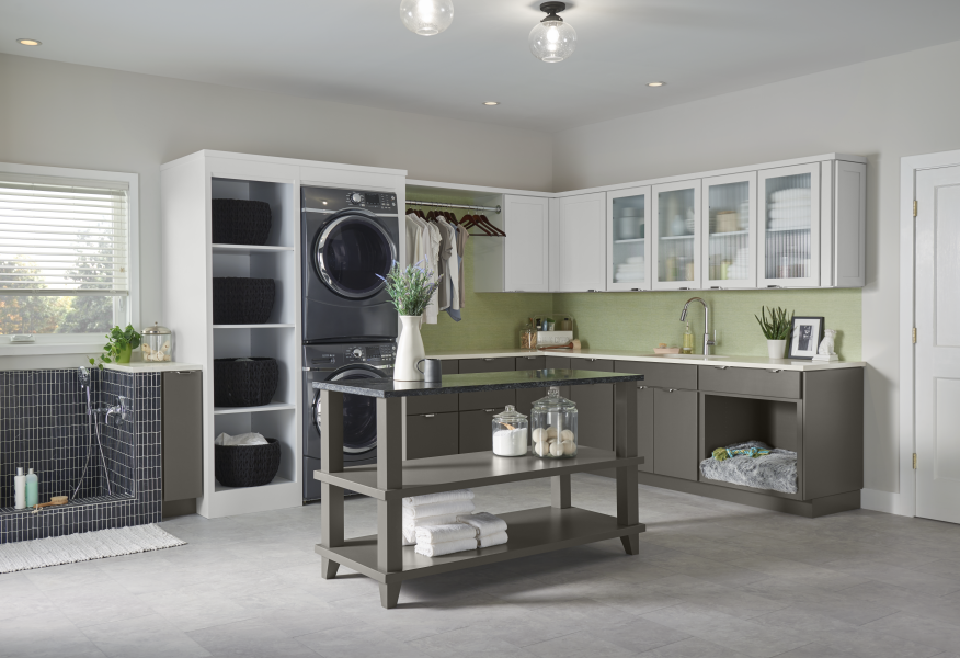 A laundry room with a washer and dryer and a sink.