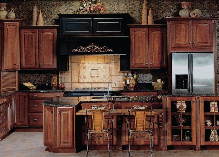 A kitchen with wooden cabinets and stainless steel appliances