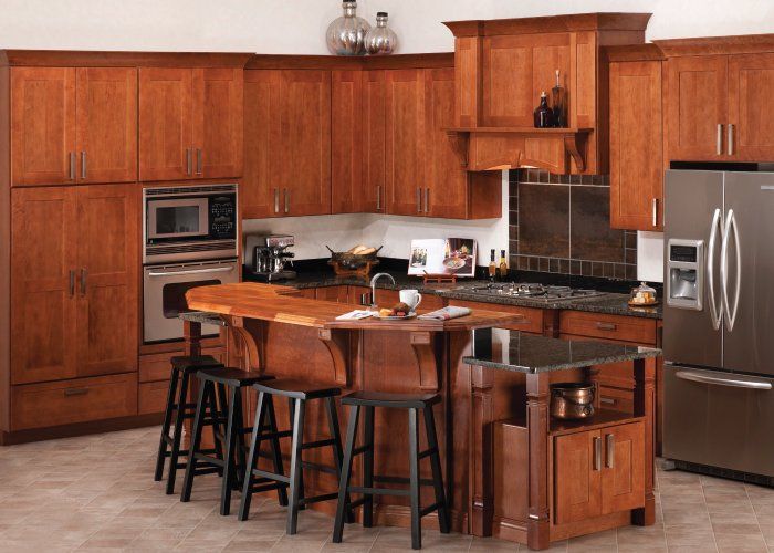 A kitchen with wooden cabinets and stainless steel appliances