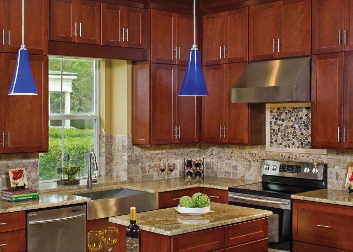 A kitchen with wooden cabinets and stainless steel appliances
