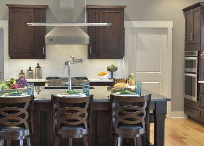A kitchen with a large island and stools