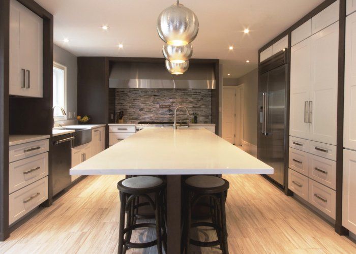 A kitchen with a large island and stools