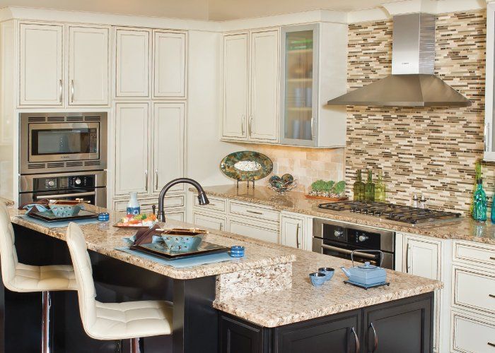 A kitchen with white cabinets and granite counter tops