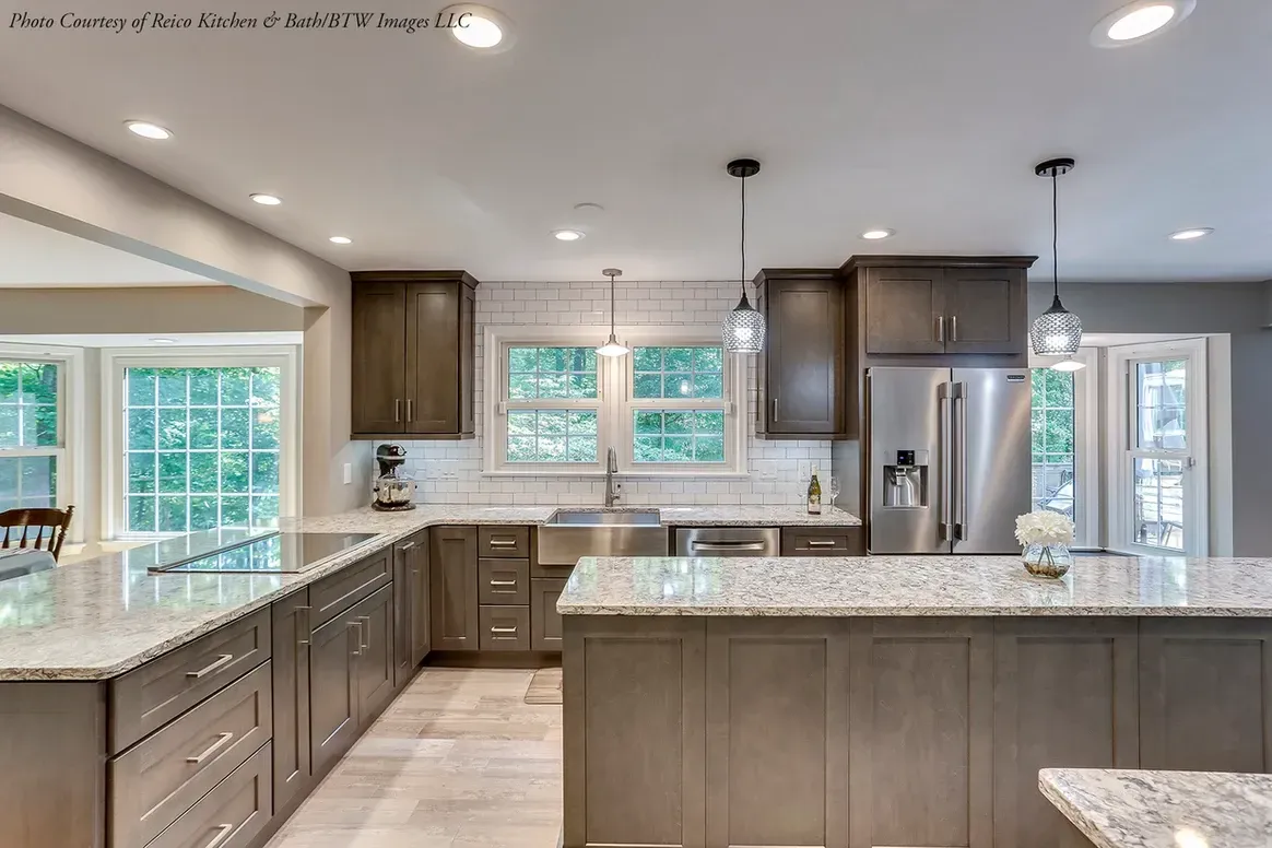 A kitchen with stainless steel appliances and granite counter tops.