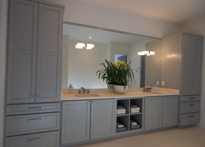 A bathroom with two sinks and a large mirror