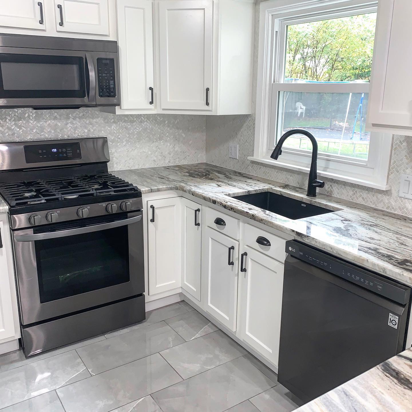 A kitchen with stainless steel appliances and white cabinets