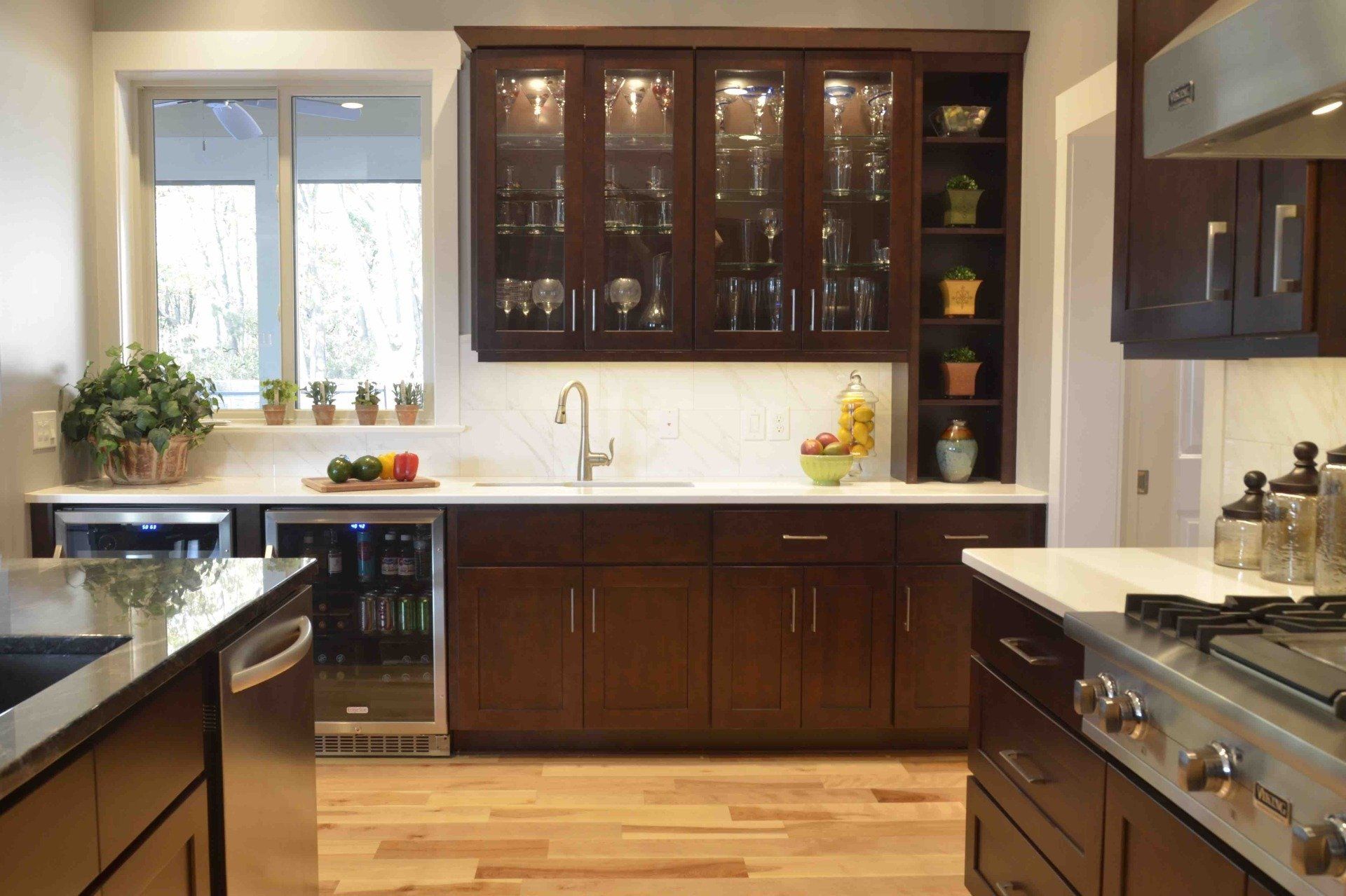 A kitchen with stainless steel appliances and wooden cabinets