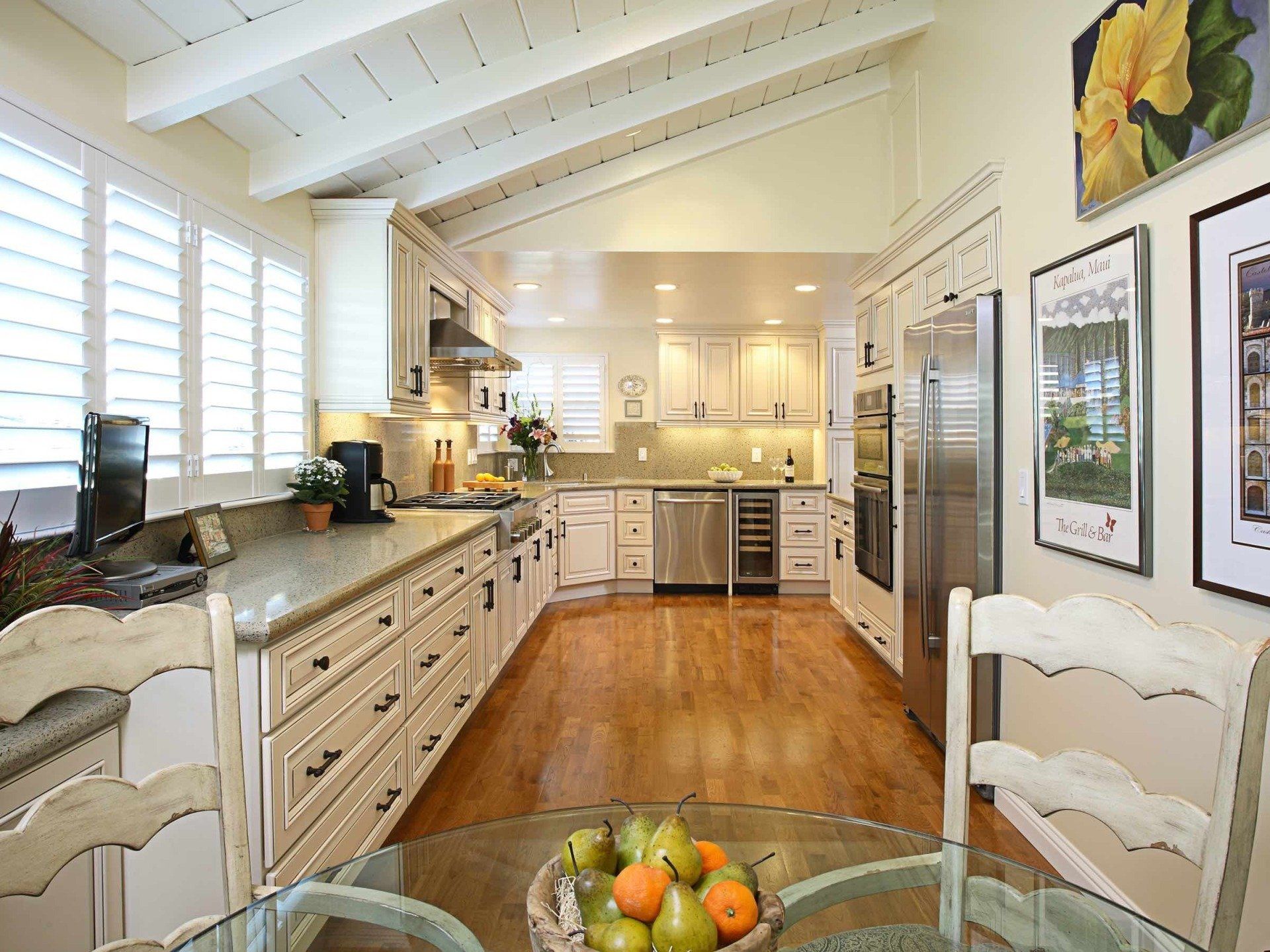 A kitchen with white cabinets and stainless steel appliances