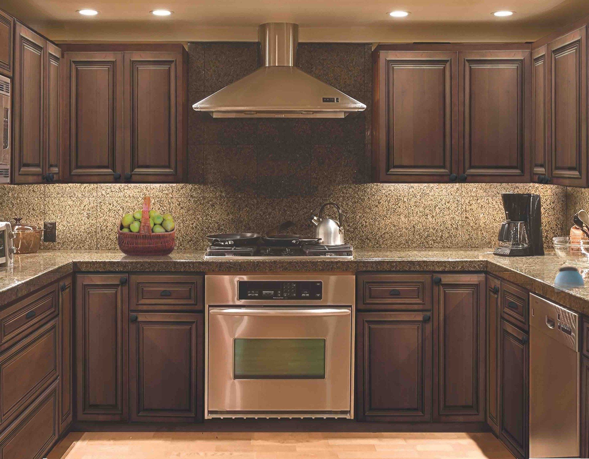 A kitchen with stainless steel appliances and wooden cabinets