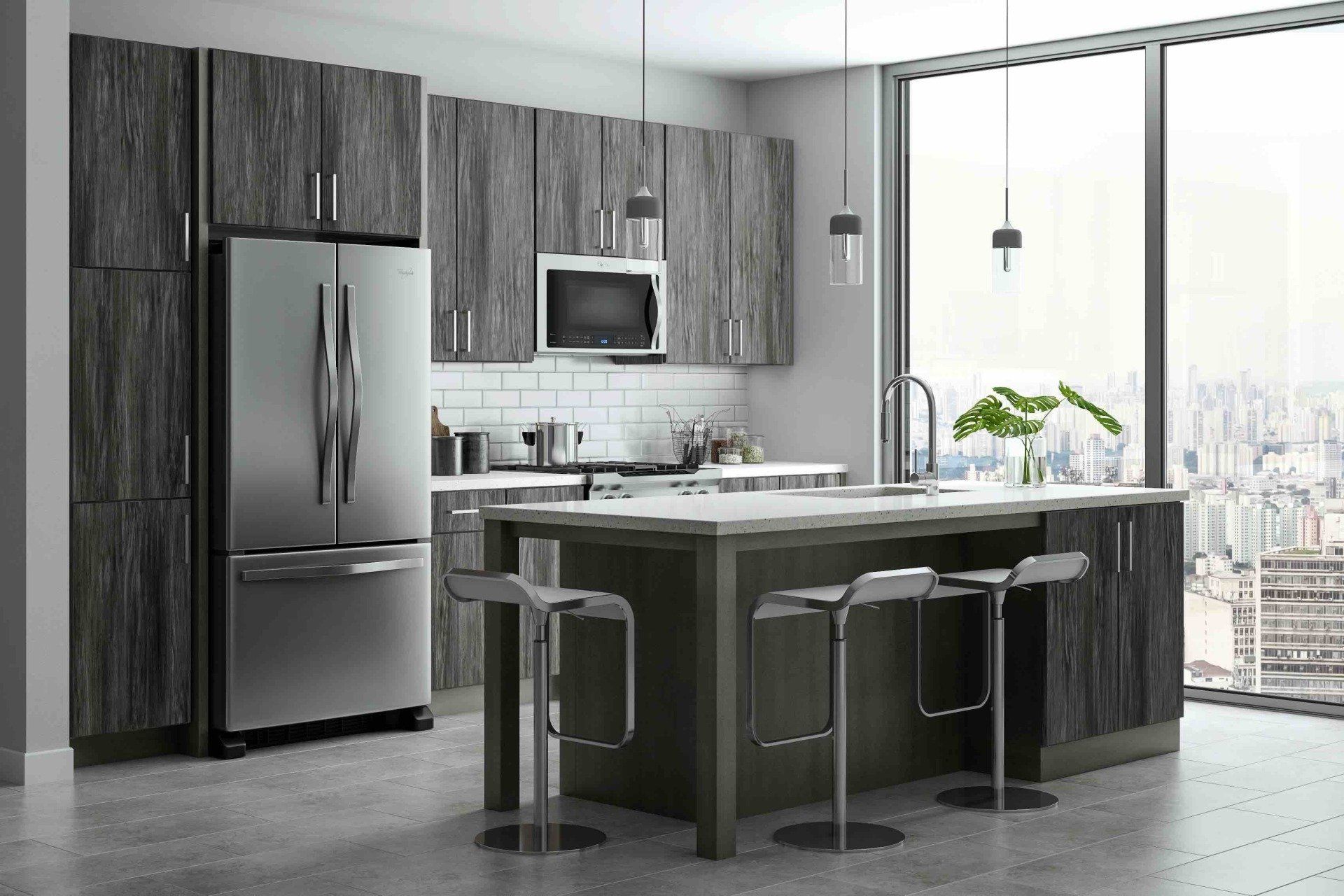 A kitchen with stainless steel appliances , gray cabinets , a large island , and a large window.