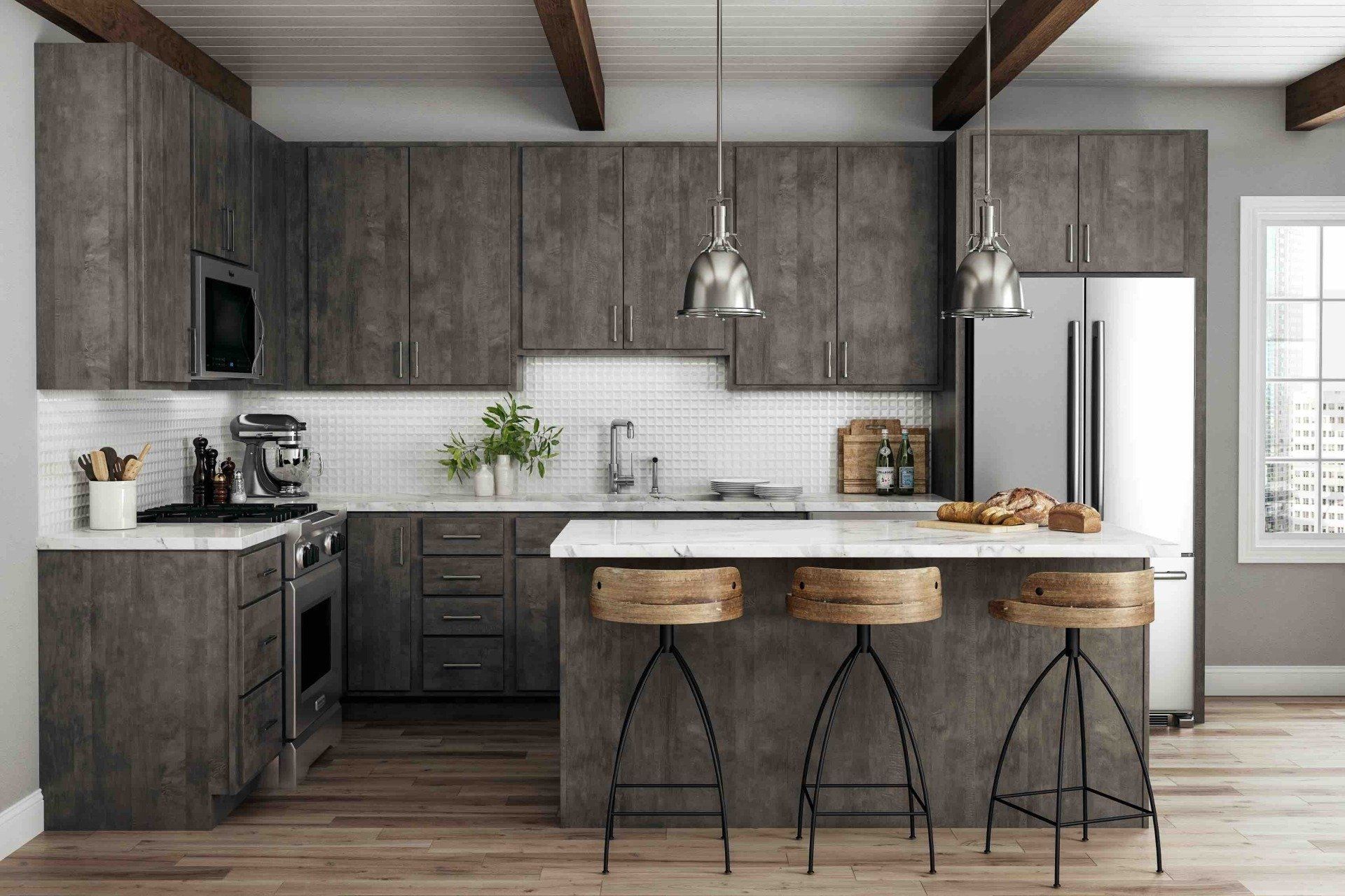 A kitchen with gray cabinets , stainless steel appliances , and a large island.