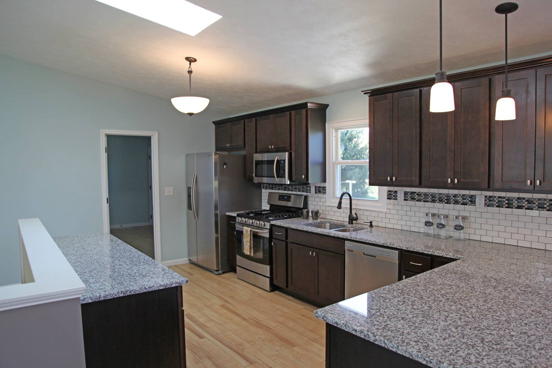 A kitchen with granite counter tops and stainless steel appliances