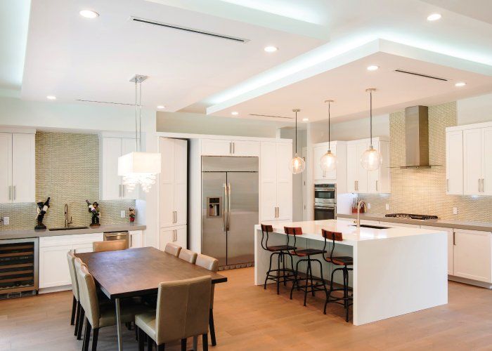 A kitchen with a table and chairs in it