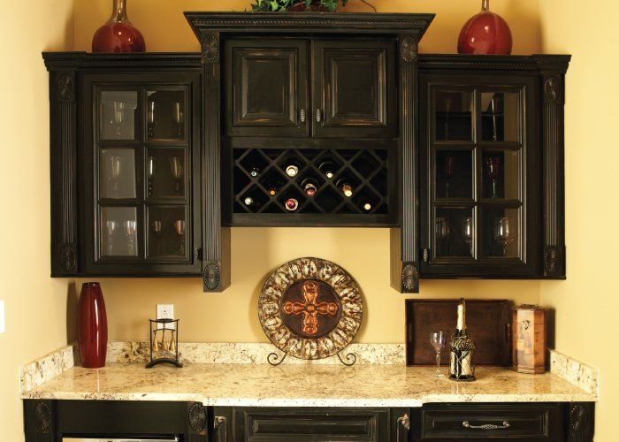 A kitchen with black cabinets and a wine rack
