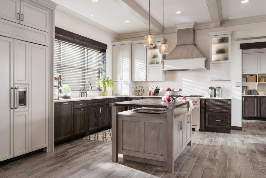 A kitchen with a large island and stainless steel appliances.