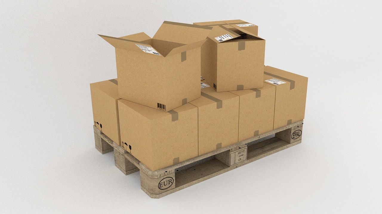 Cardboard boxes stacked on a wooden pallet, ready for shipping.