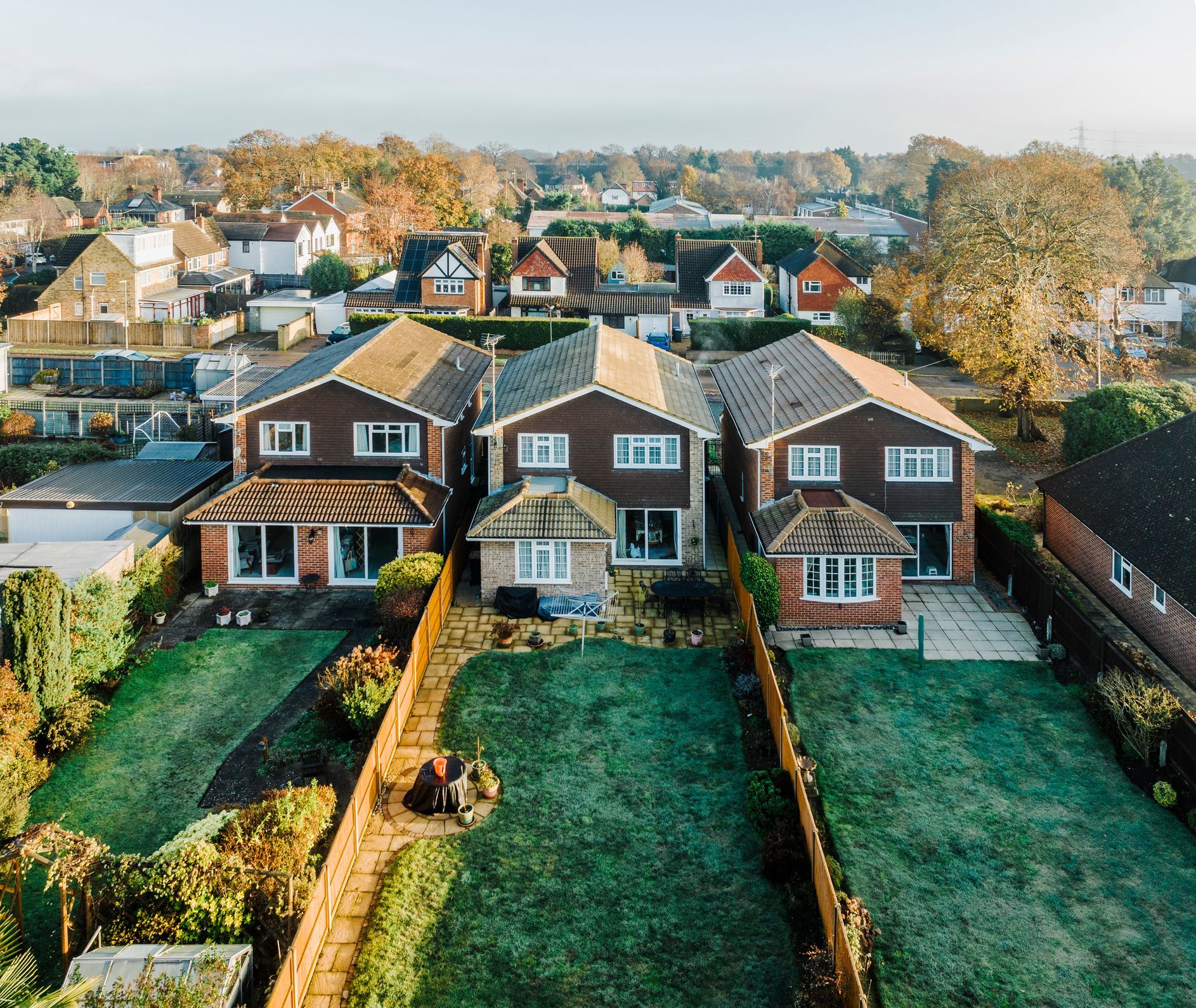 An aerial view of a residential area with houses and a large lawn.