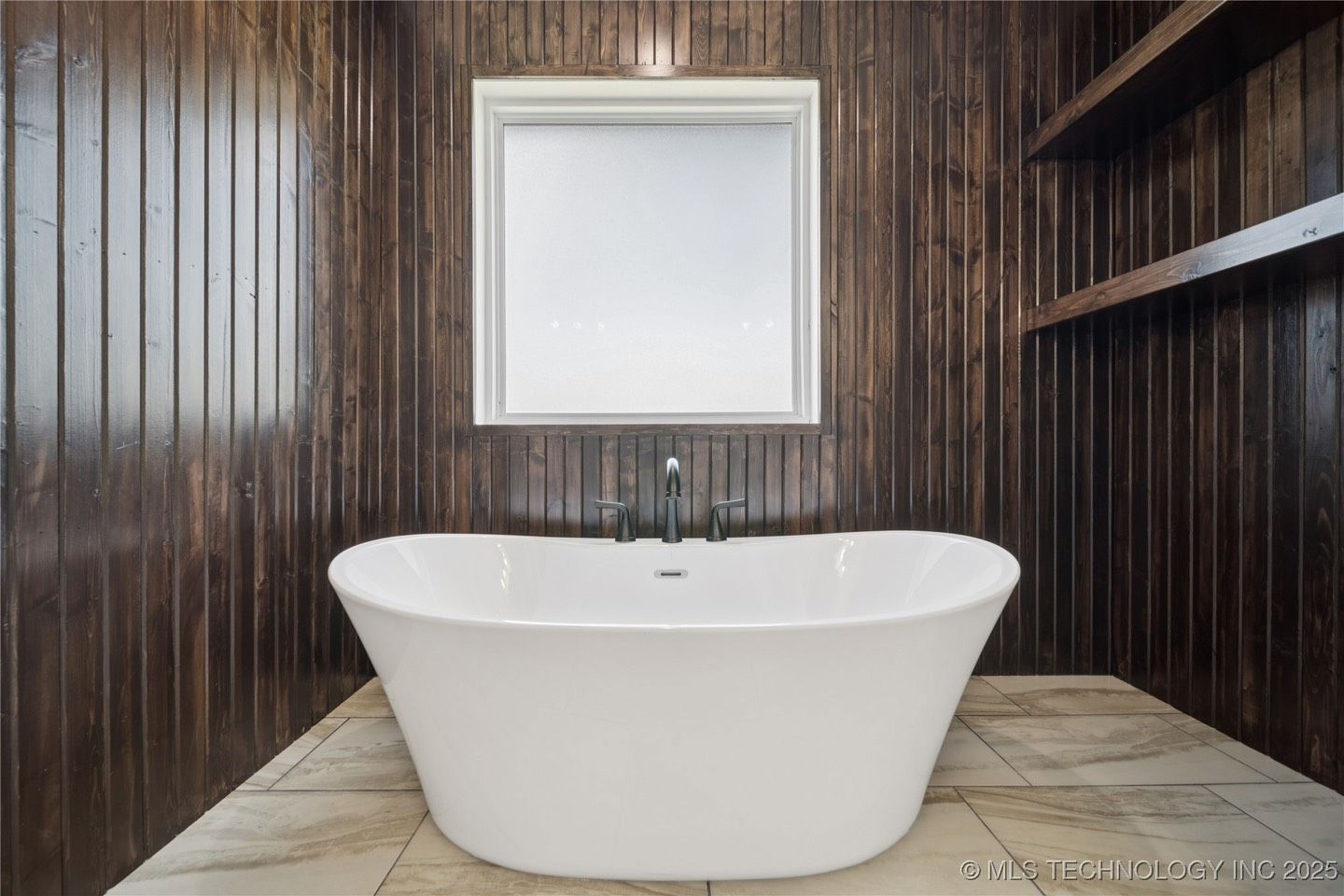A bathroom with a white bathtub and a mirror.