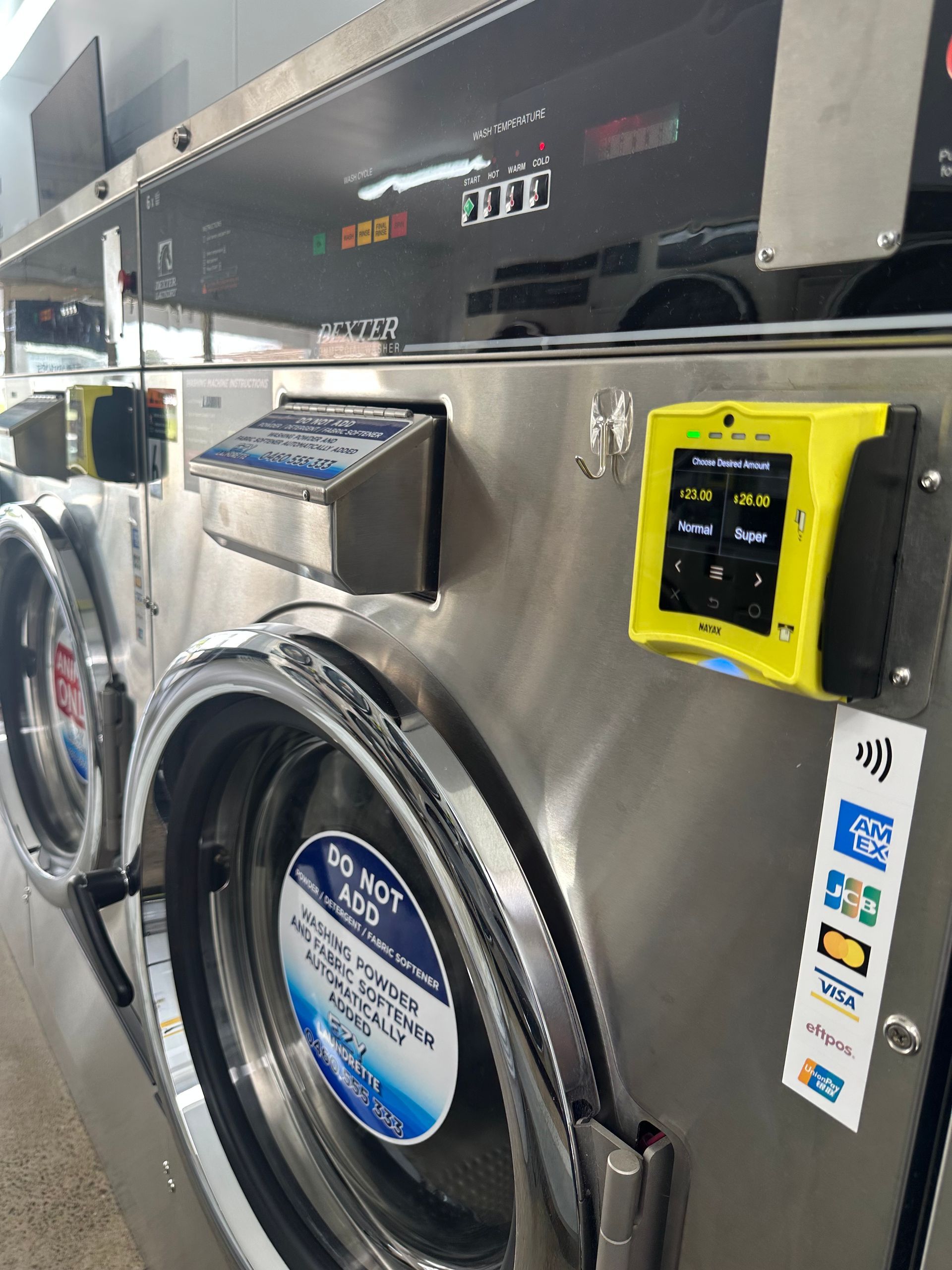 An Eftpos Machine Attached To A Washing Machine — Ezy Laundrette Diamond Beach in Diamond Beach, NSW