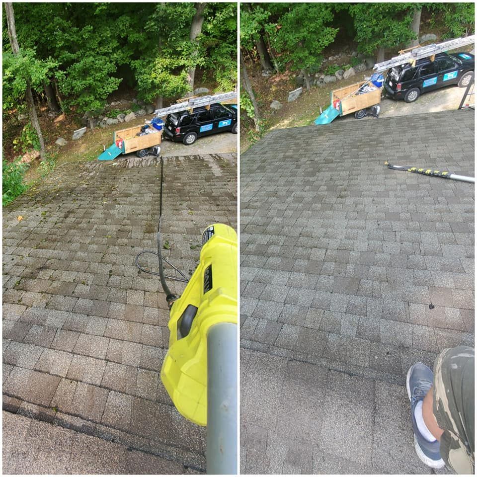 A person is cleaning a roof with a yellow vacuum cleaner.