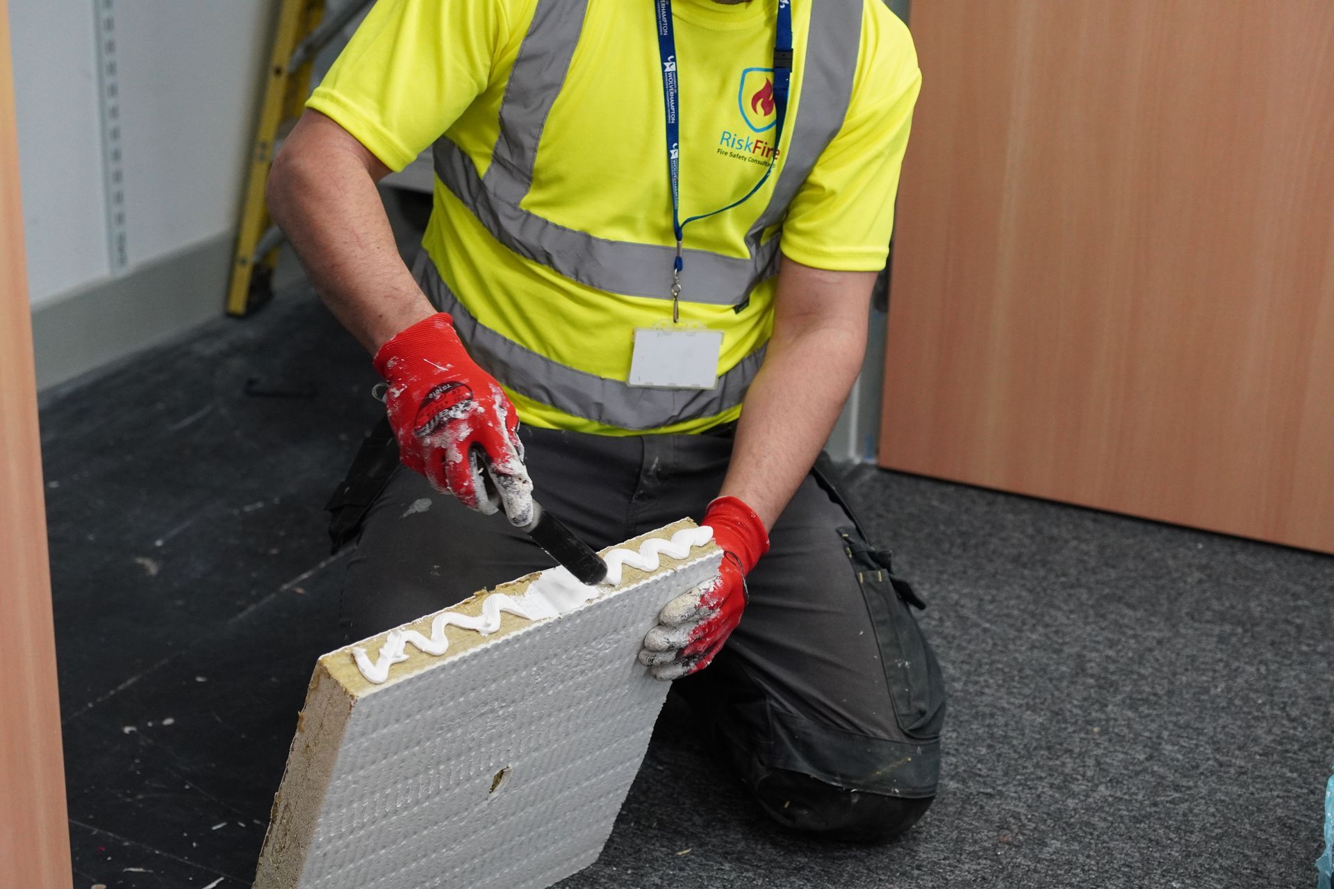A man is working on a ventilation system in a building.