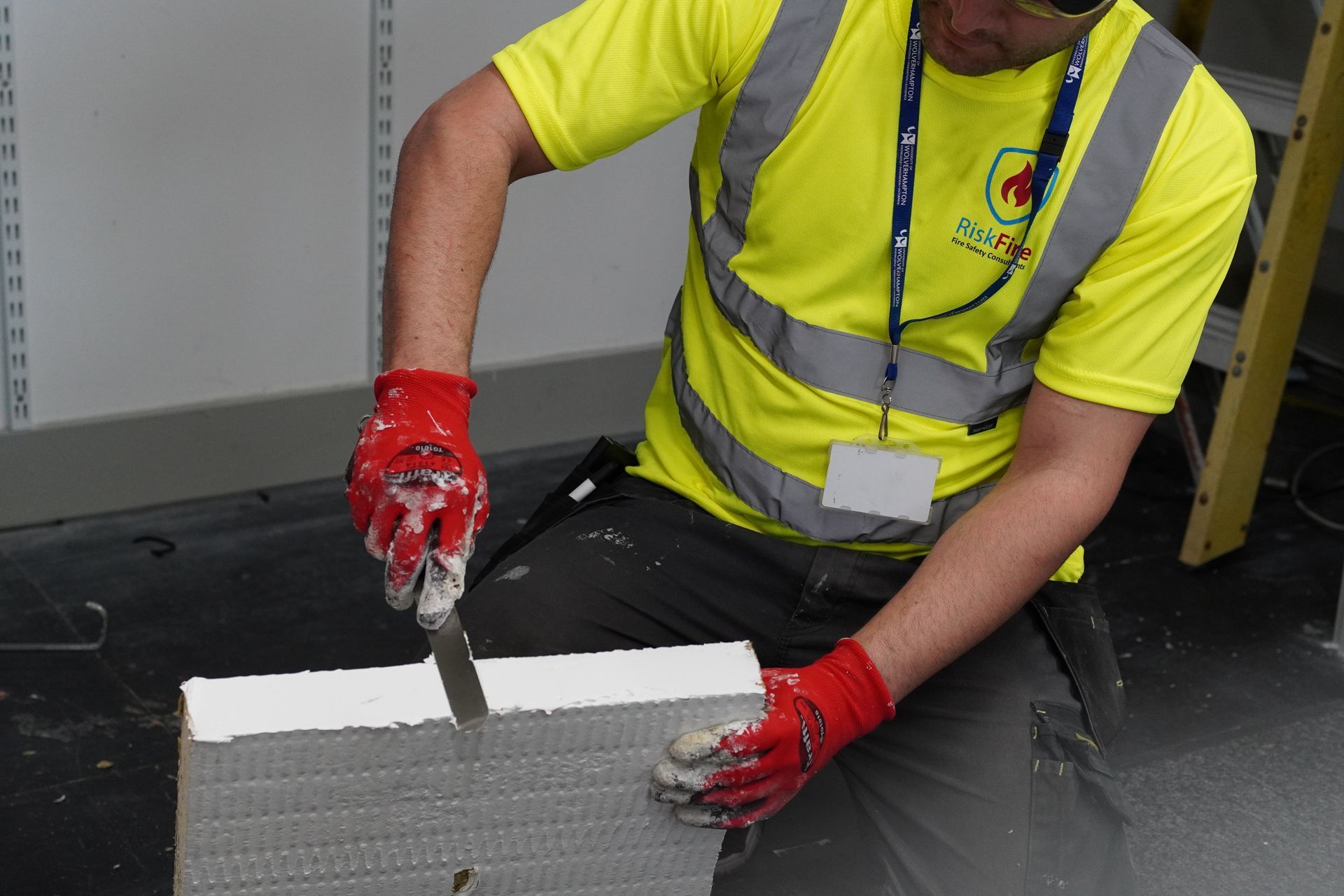 A man is working on a ventilation system in a building.