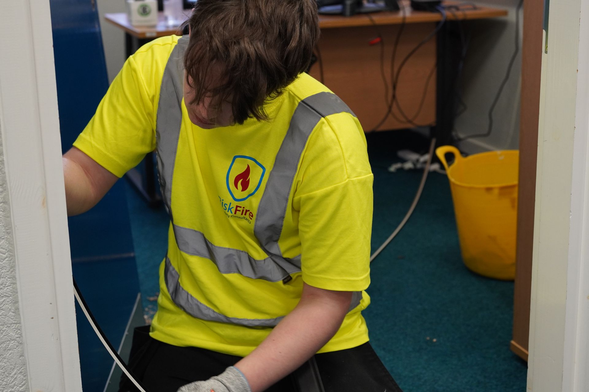 A group of people are looking at a blueprint on a table.