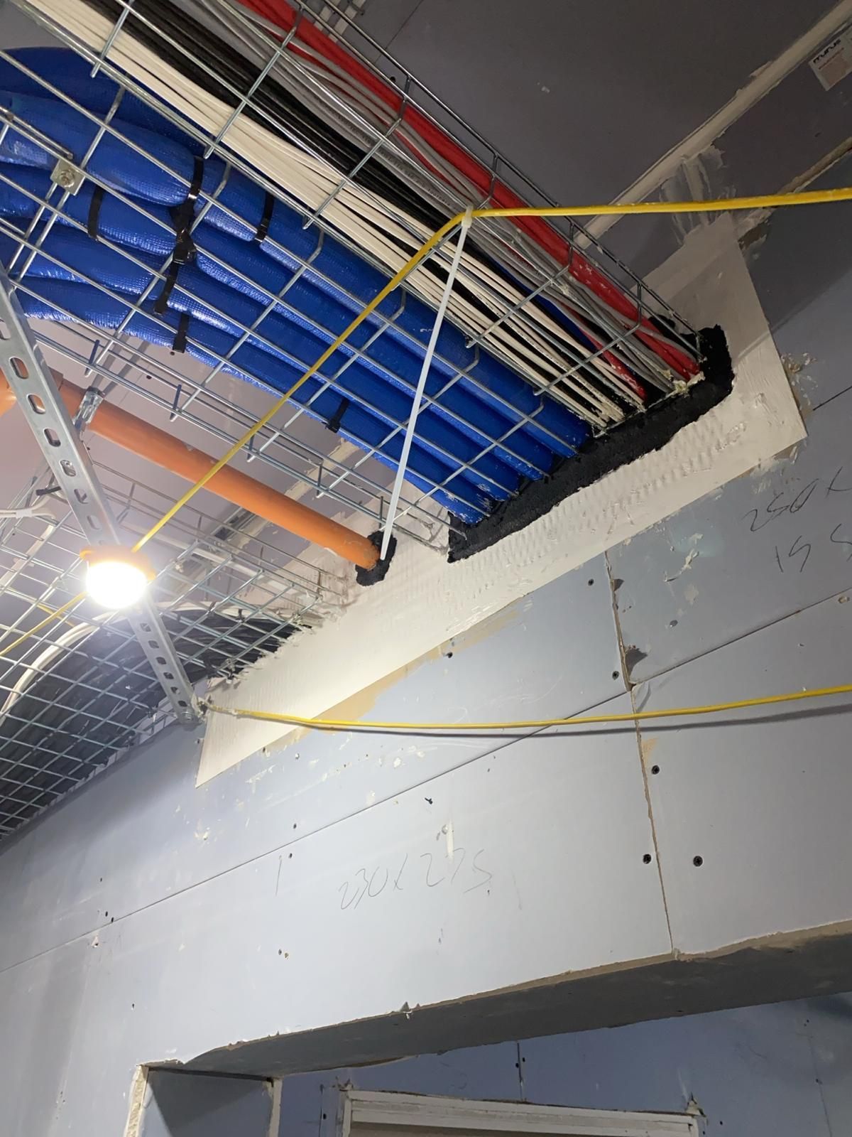 A ceiling with a lot of wires hanging from it