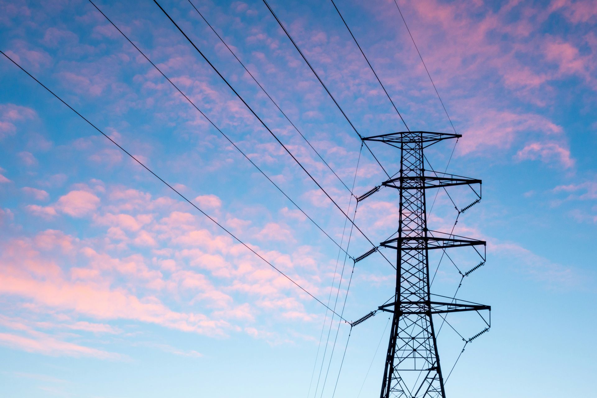 A power tower with a sunset sky in the background.