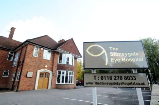 The Stoneygate Eye Hospital building with sign. Brown brick, beige sign with contact info.