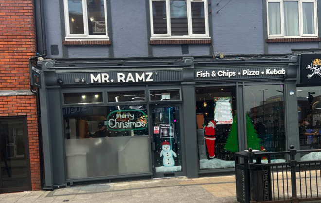 A restaurant called mr. ramz is located on a city street.